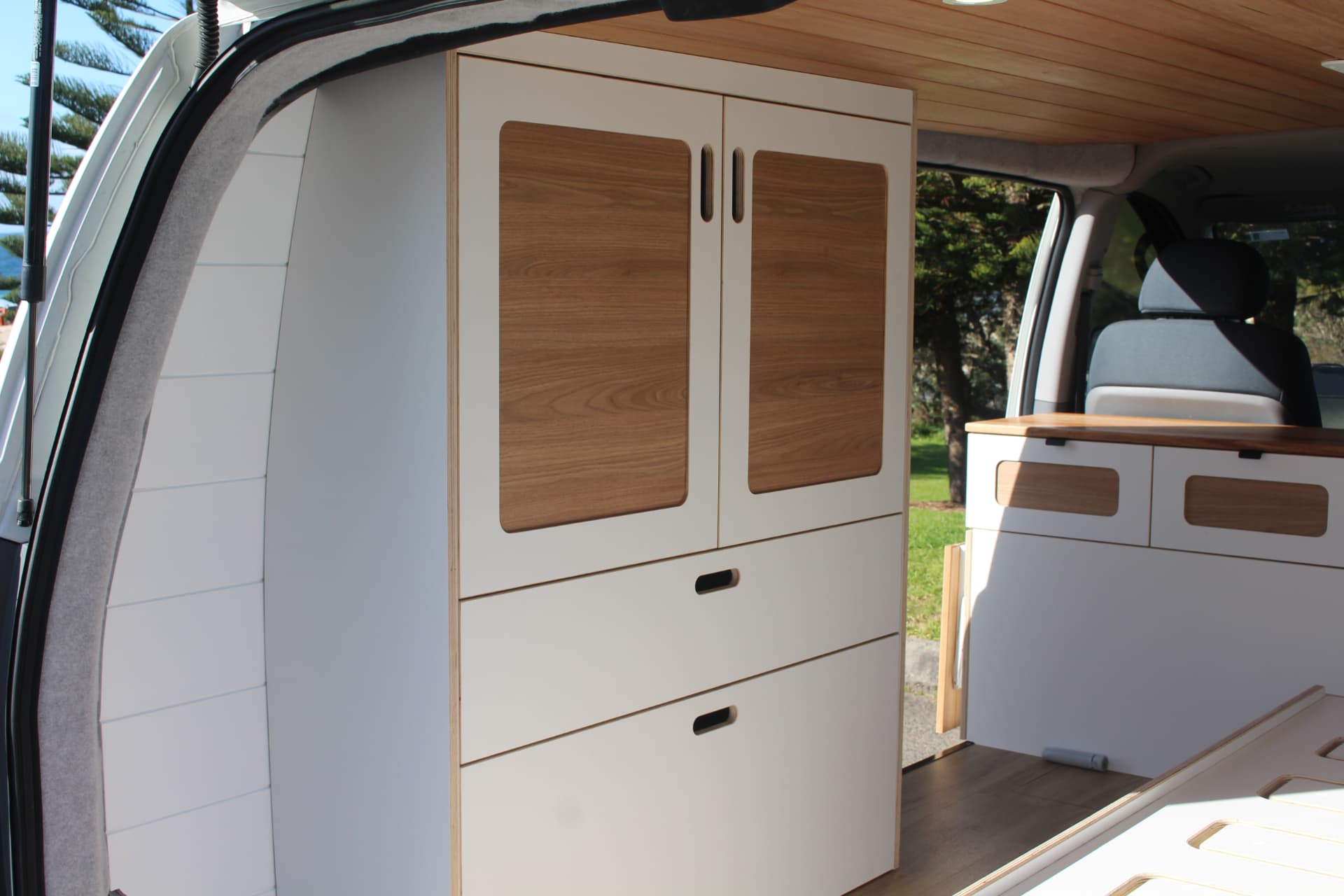 Custom cabinetry and storage inside a van fitout