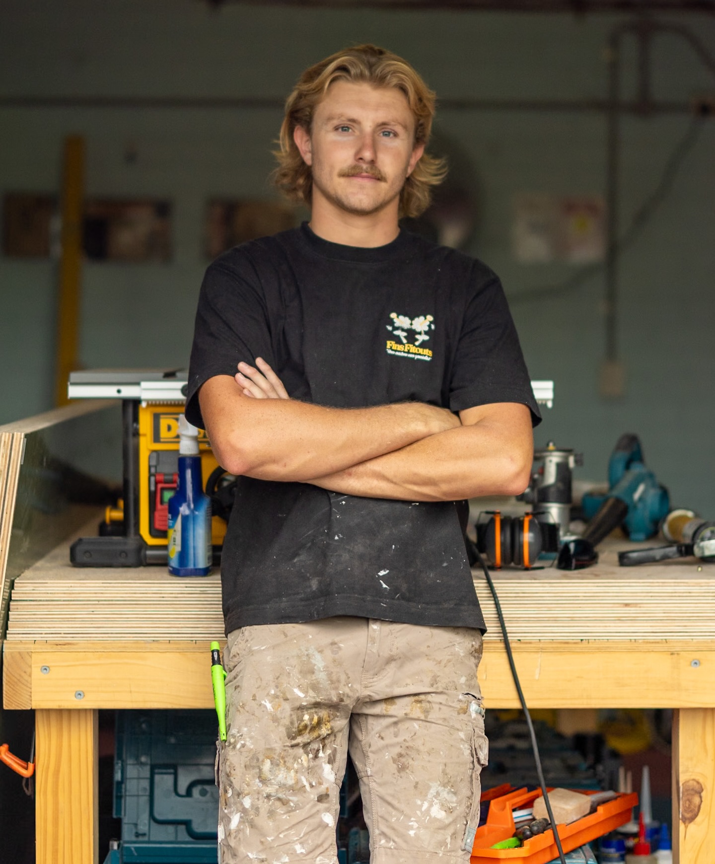Fin standing at his workbench in the Cronulla workshop