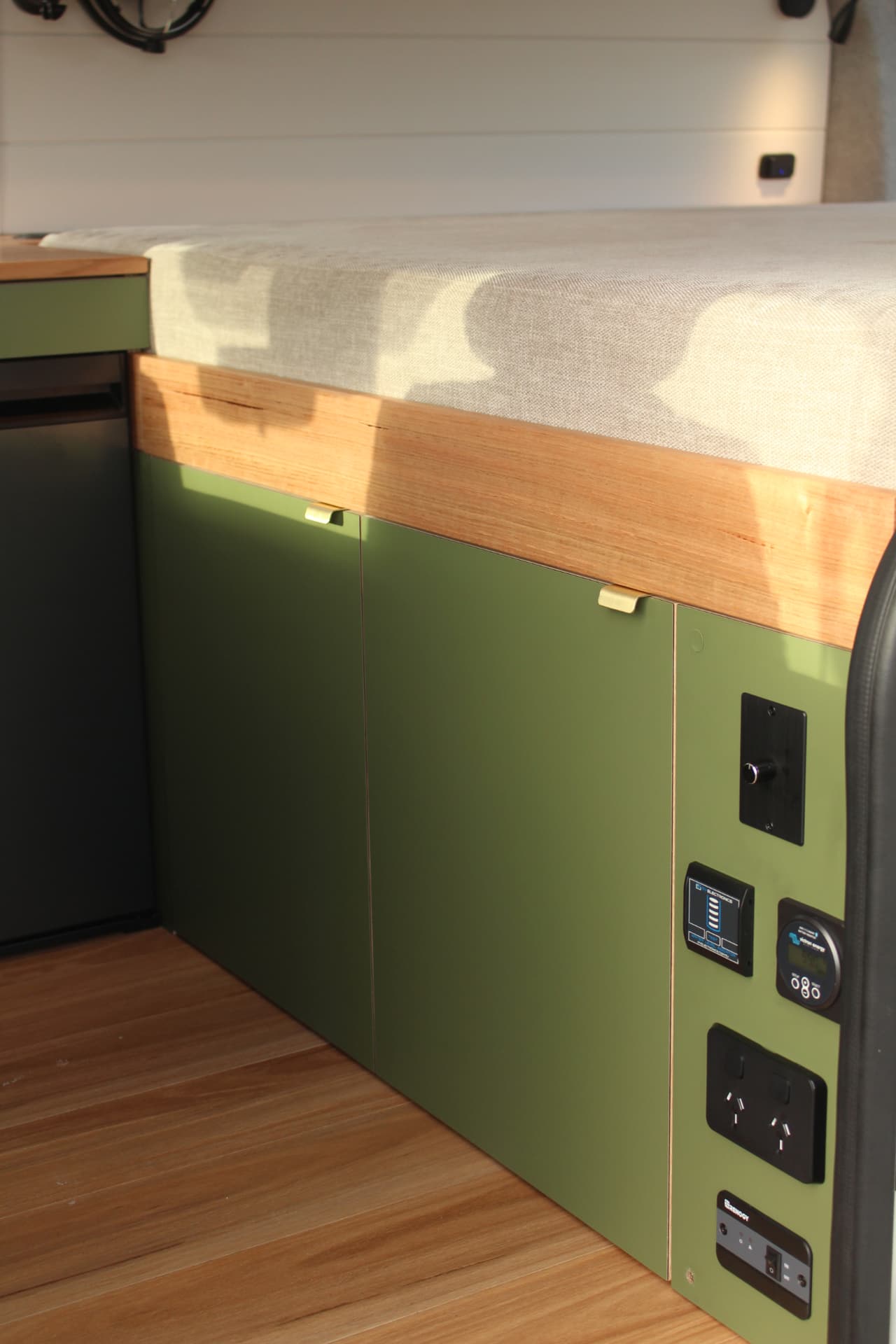 Toyota Hiace 300 Series — Olive cabinet run with concealed lighting under the bed