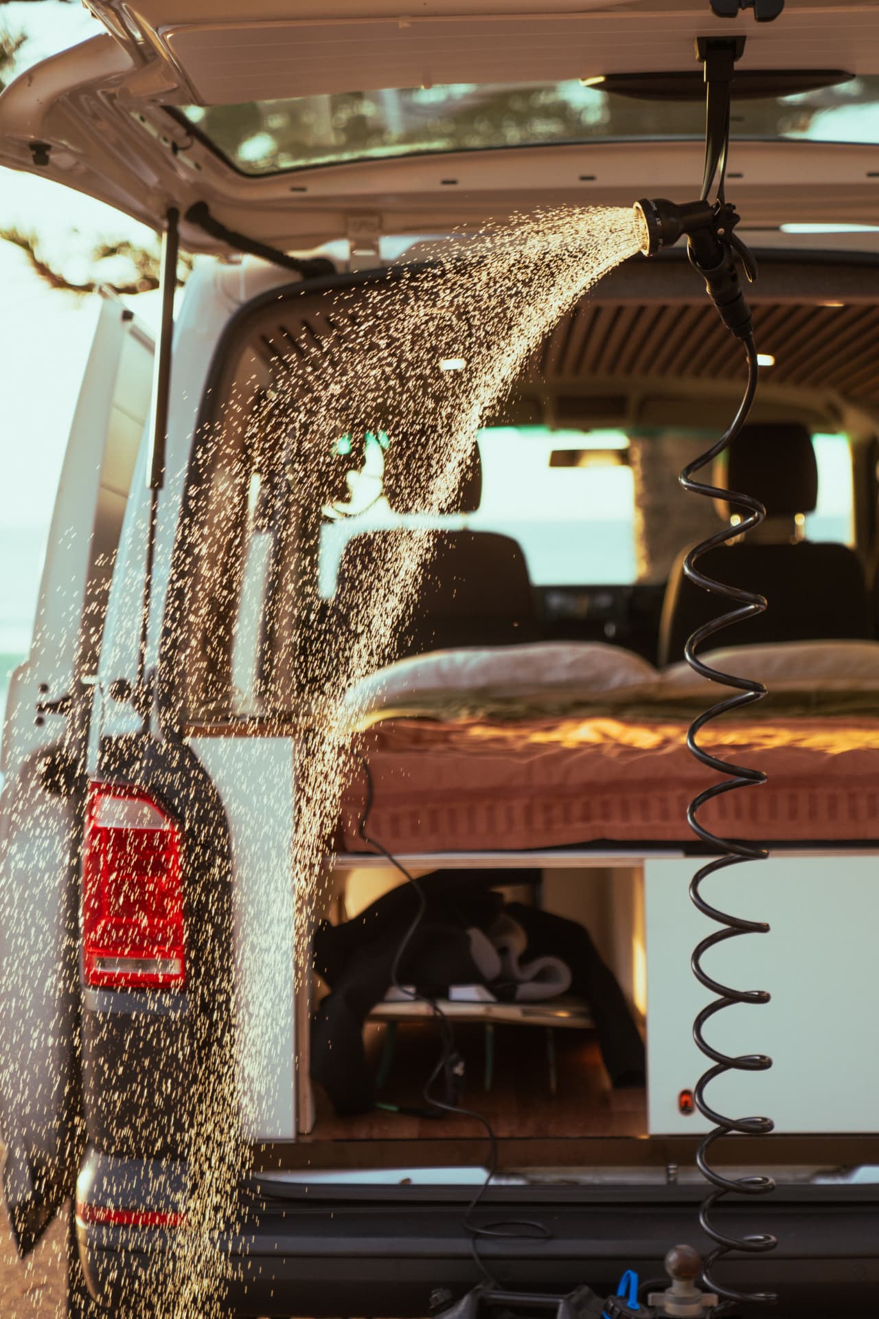VW Transporter — Shower head on its coiled hose off the tailgate