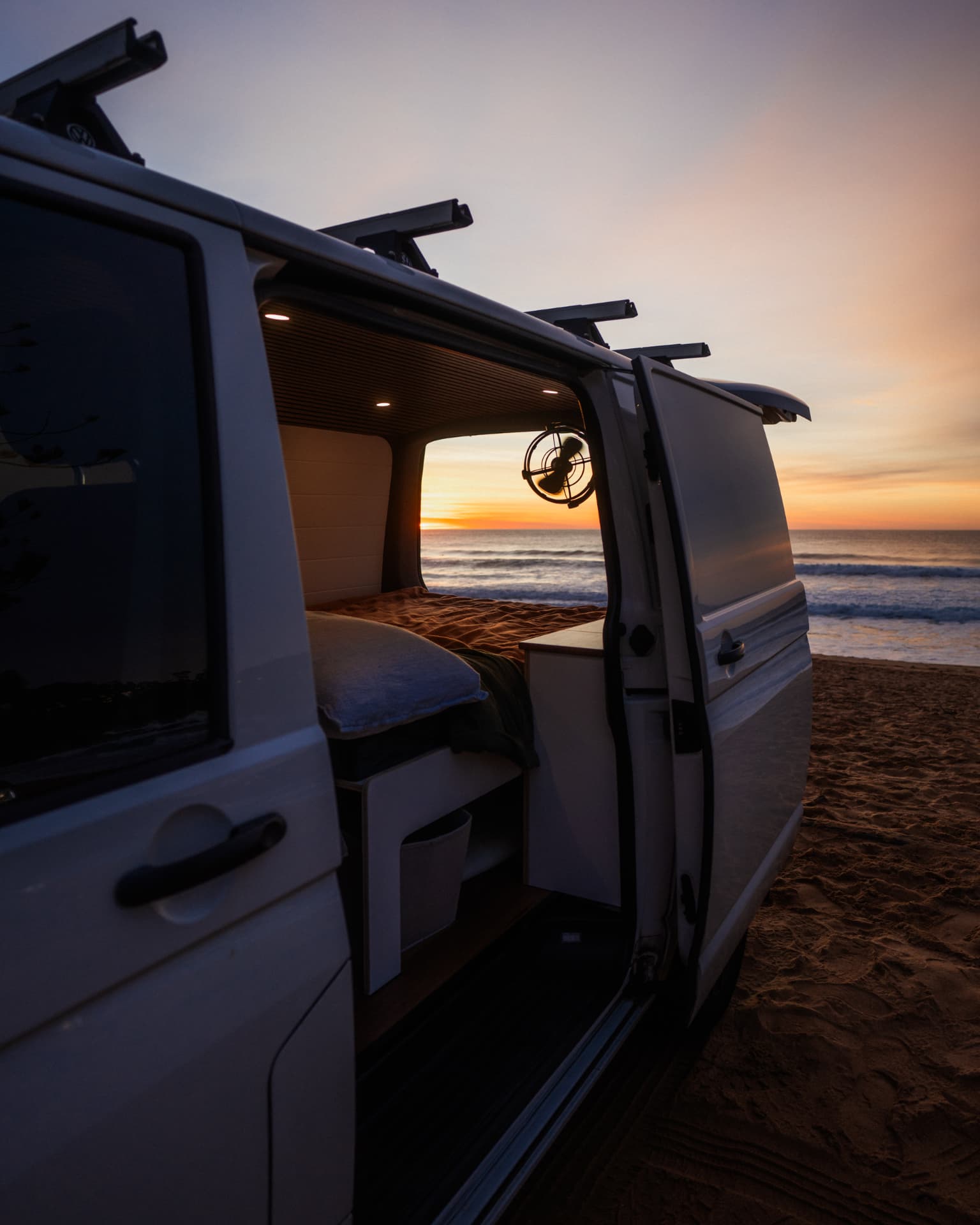 VW Transporter — Side door open at sunset on the sand