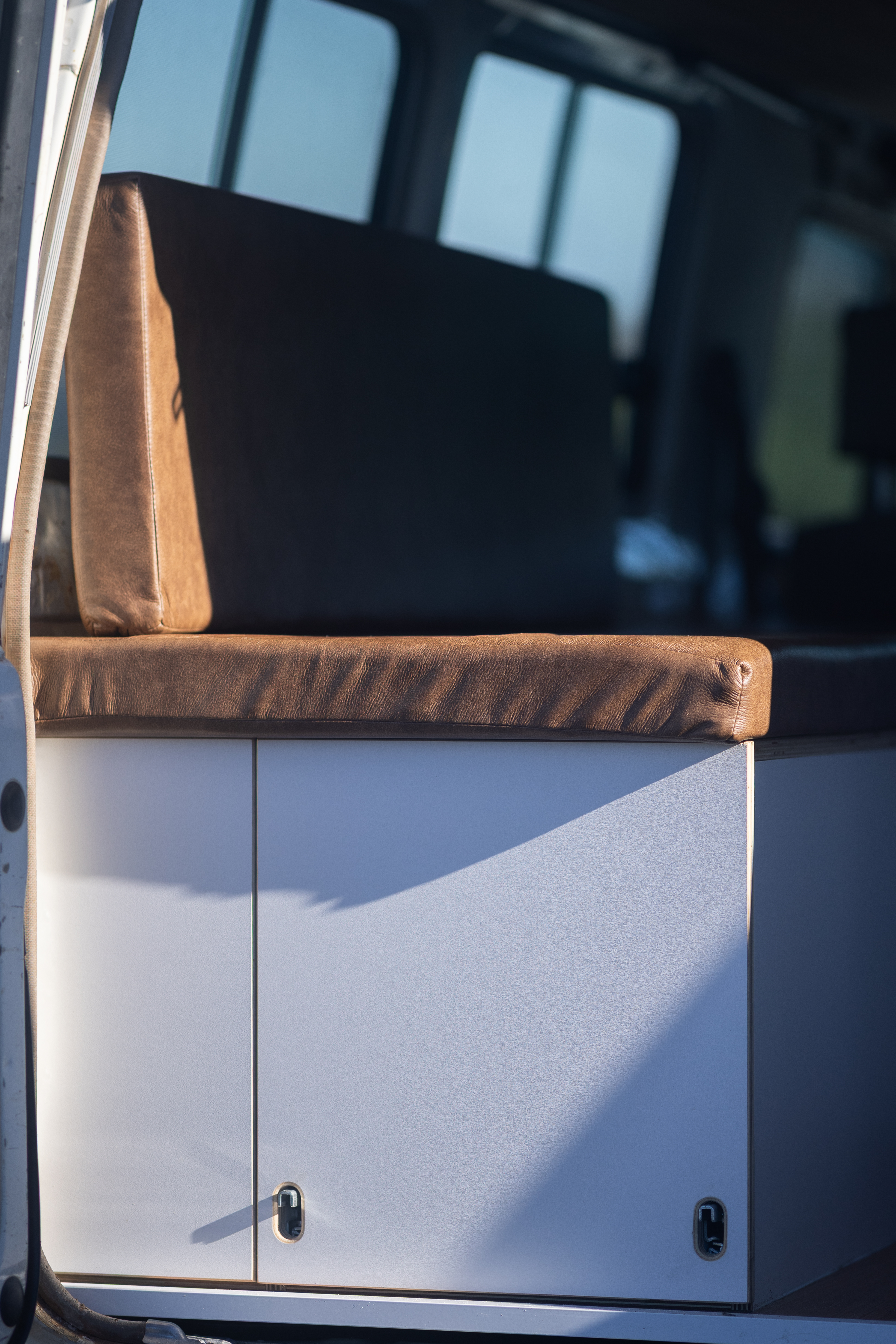 Toyota Troop Carrier — Bench seat and cabinetry from the side door