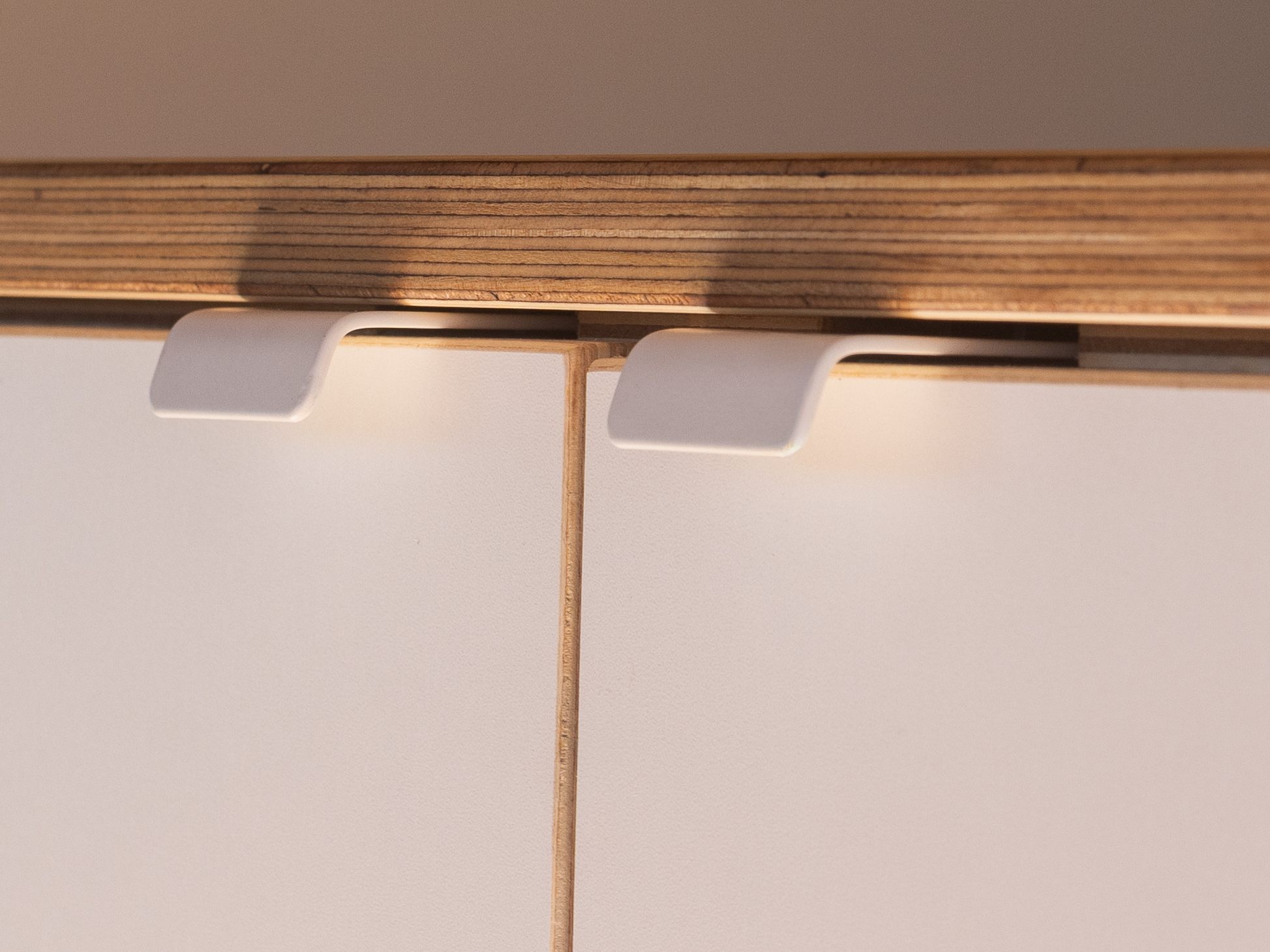 Toyota Troop Carrier — Recessed finger pulls under warm lighting
