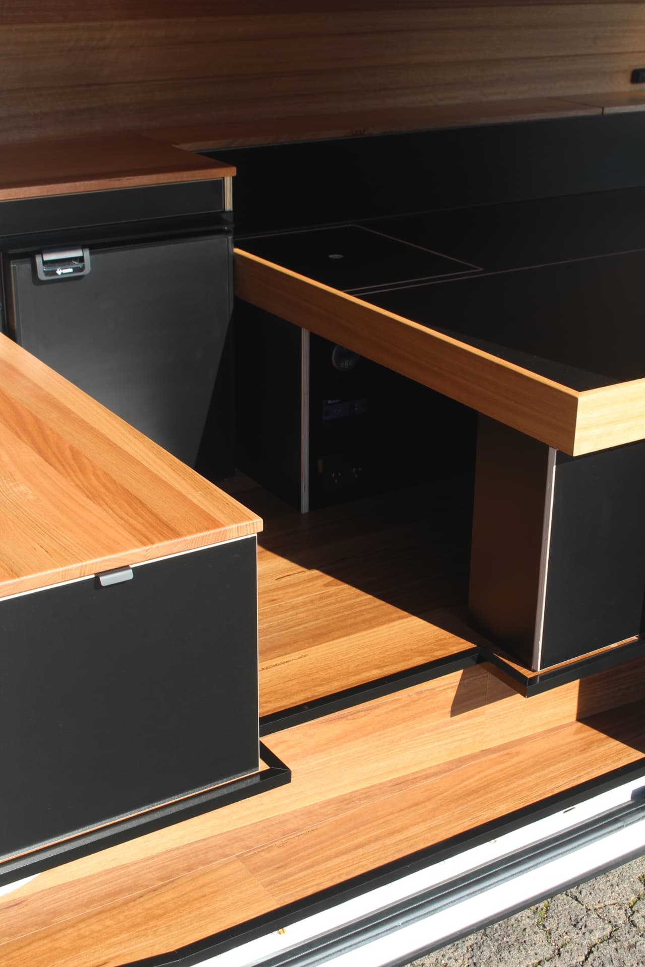 Hiace 200 Series Weekender — Side door open — kitchen, fridge and hardwood floor
