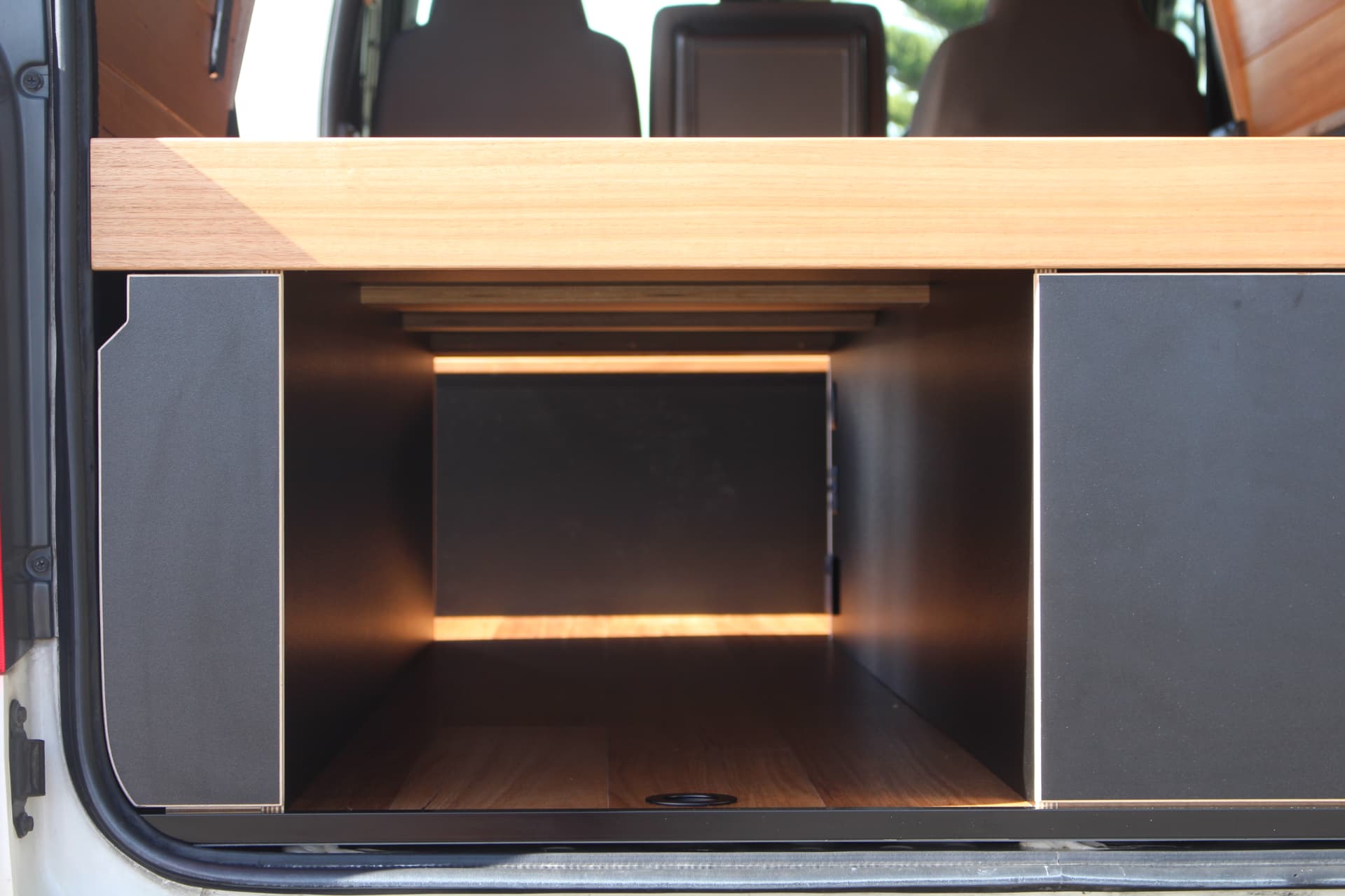 Hiace 200 Series Weekender — Open storage bay under the bed platform