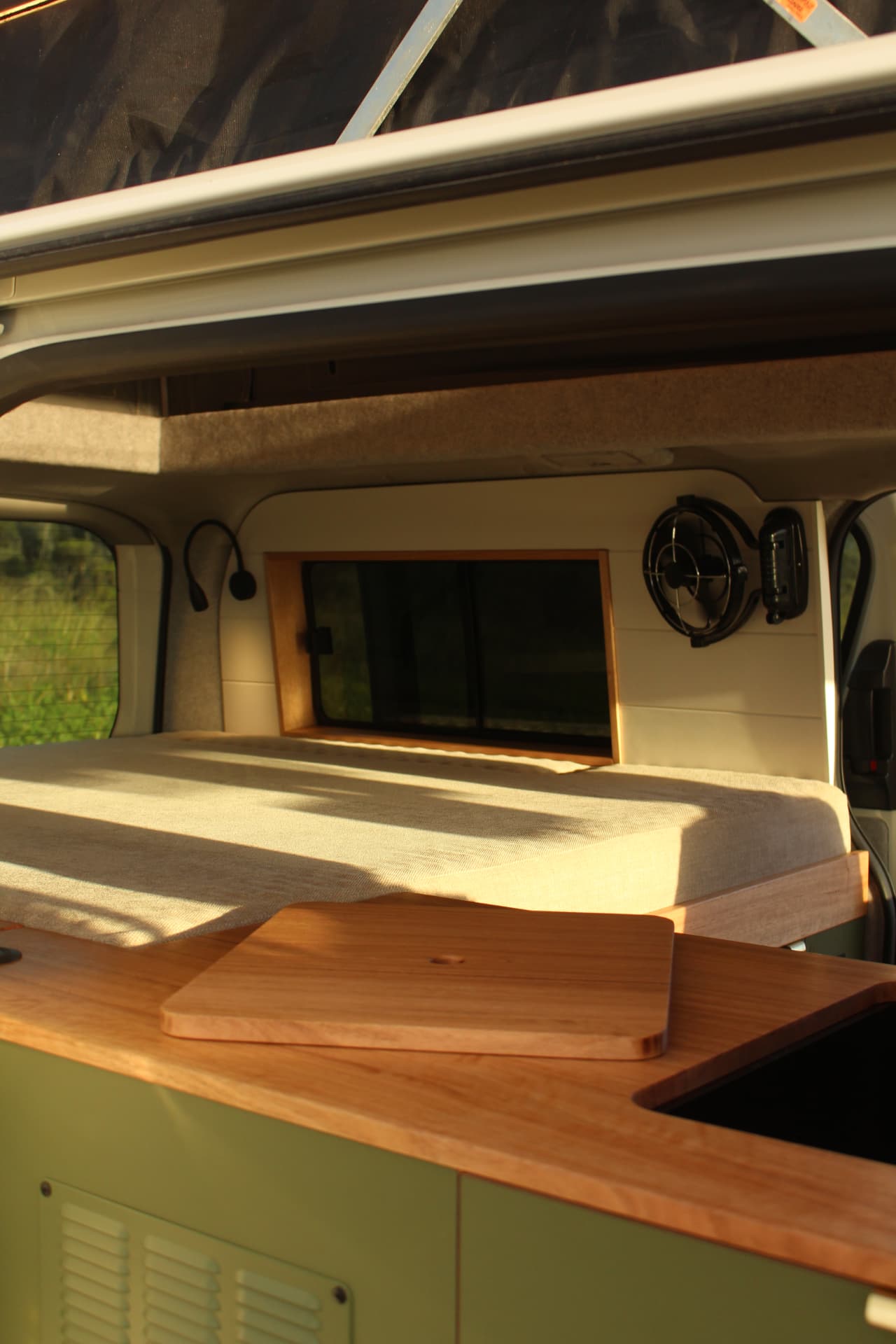 Toyota Hiace 300 Series — Timber lid on the bench looking through to the bed