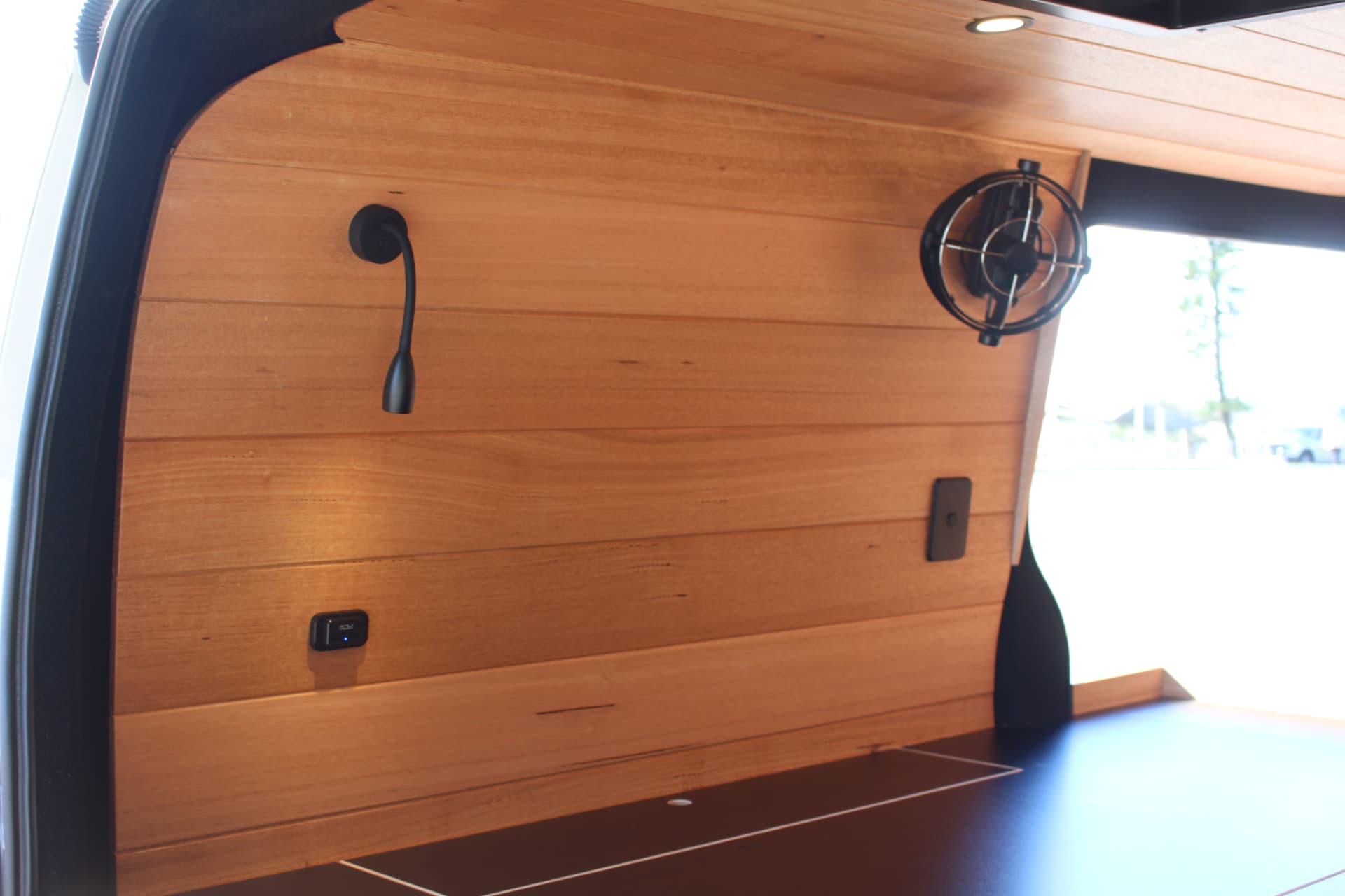 Hiace 200 Series Weekender — Swivel fan and light on the timber-lined door wall