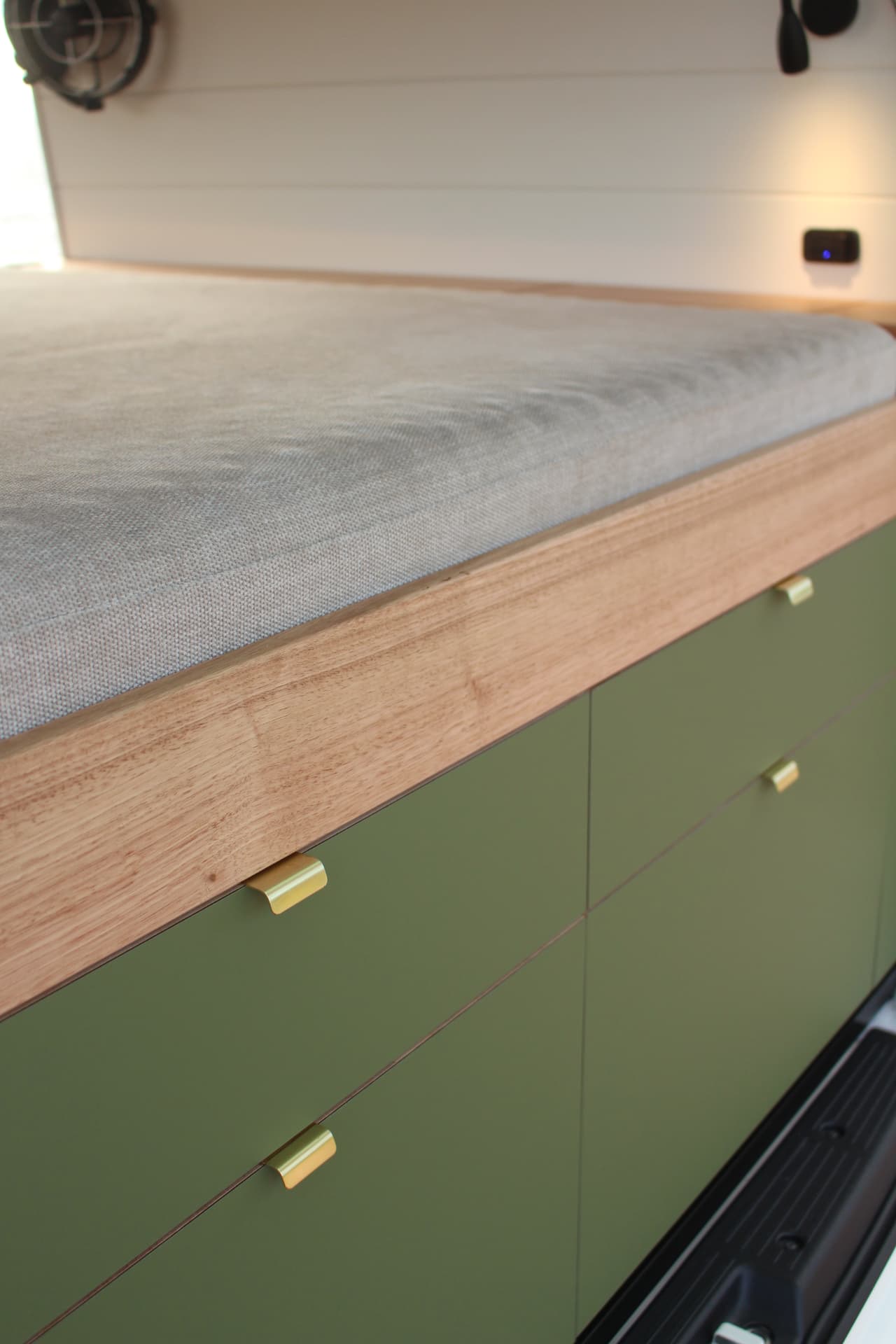 Toyota Hiace 300 Series — Bed platform edged in hardwood over the drawer bank