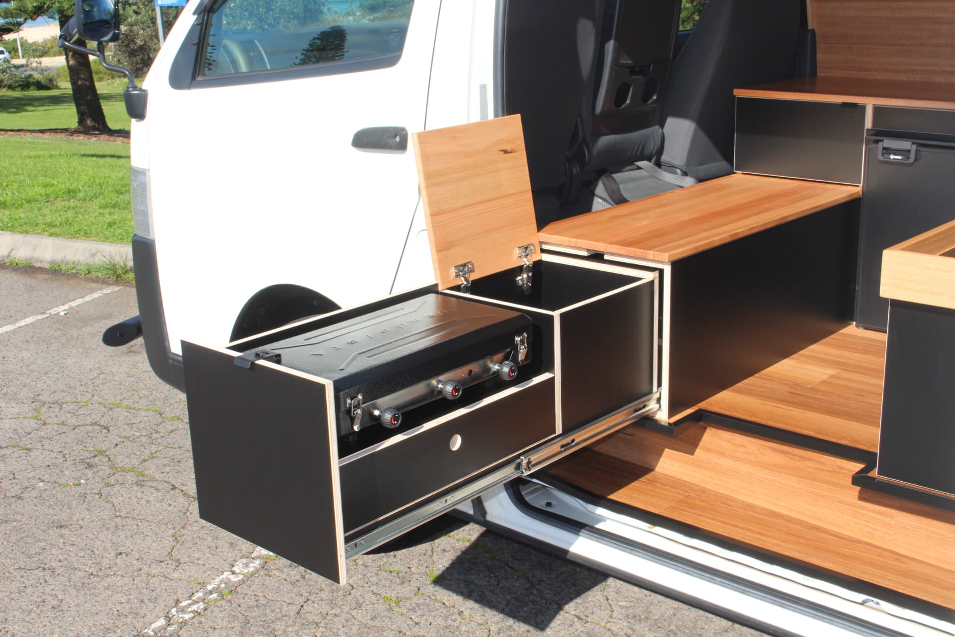 Hiace 200 Series Weekender — Cooker and prep bench set up outside