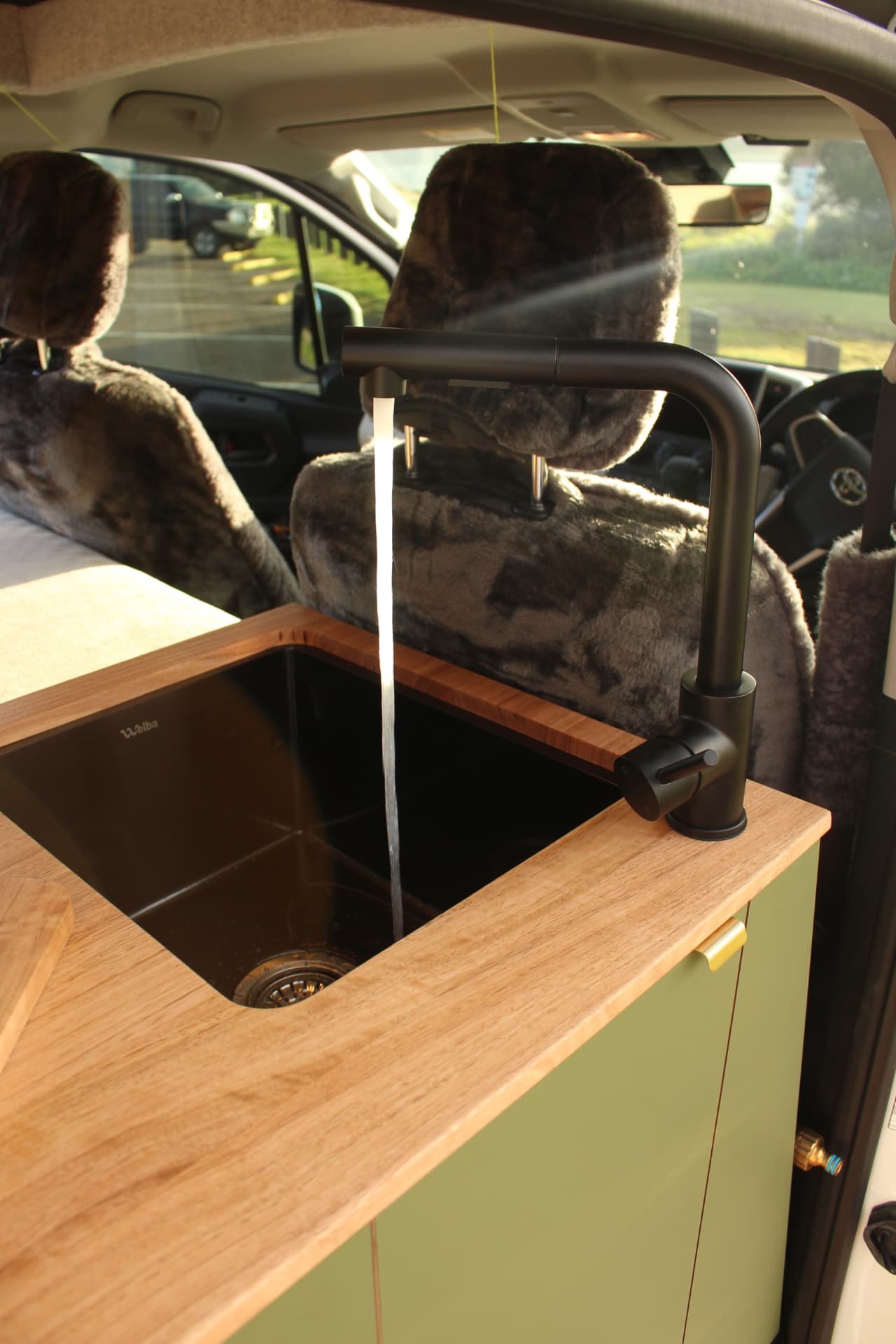 Toyota Hiace 300 Series — Black mixer running over the undermount sink
