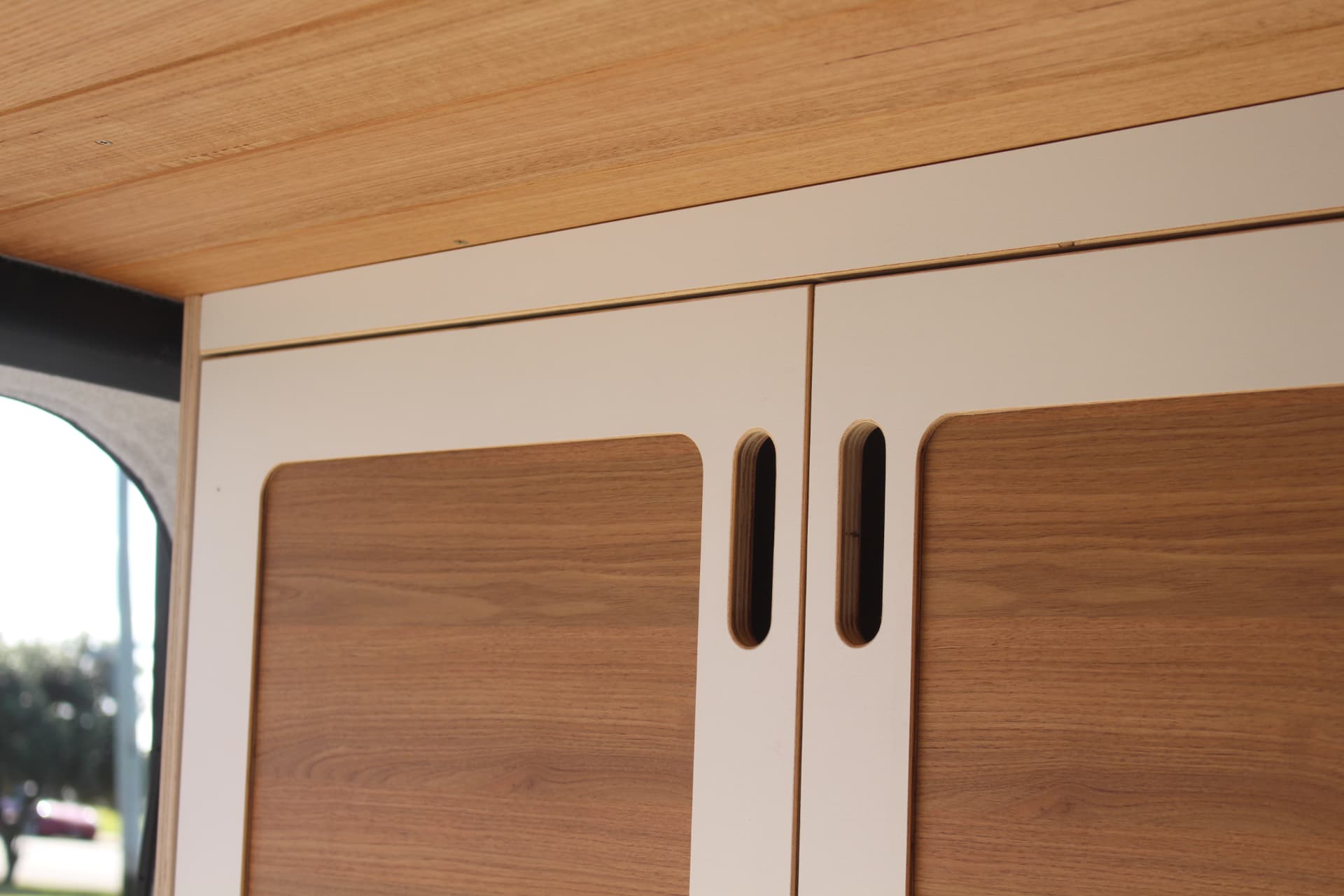 iLoad Camper — Timber ceiling meeting the overhead lockers