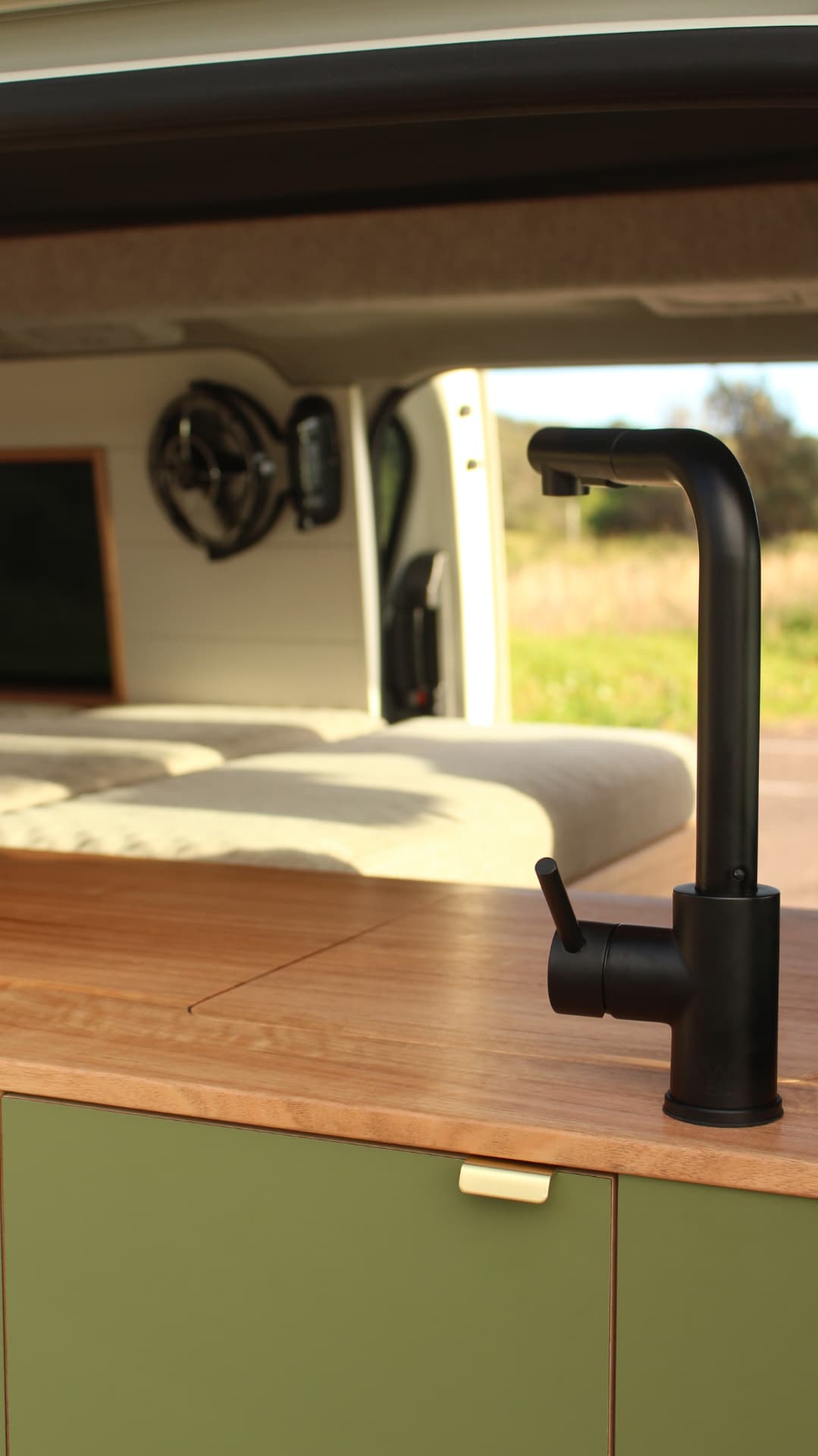 Toyota Hiace 300 Series — Black mixer with the bed beyond