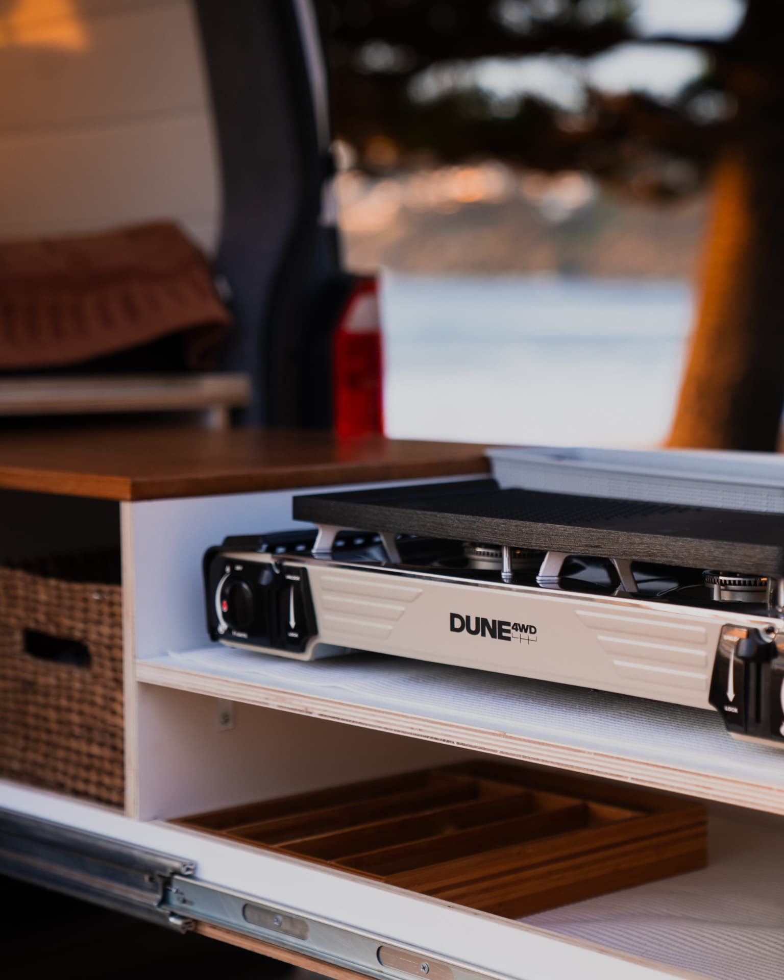 VW Transporter — Dune cooktop on the slide-out, timber benchtop above