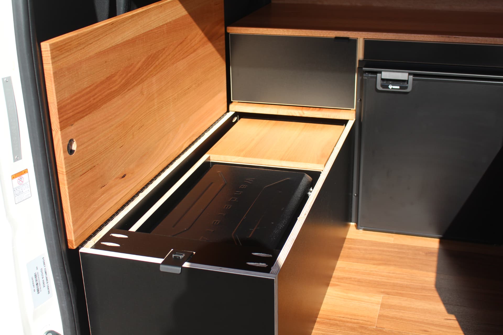 Hiace 200 Series Weekender — Bench lid open on the slide-out cooker