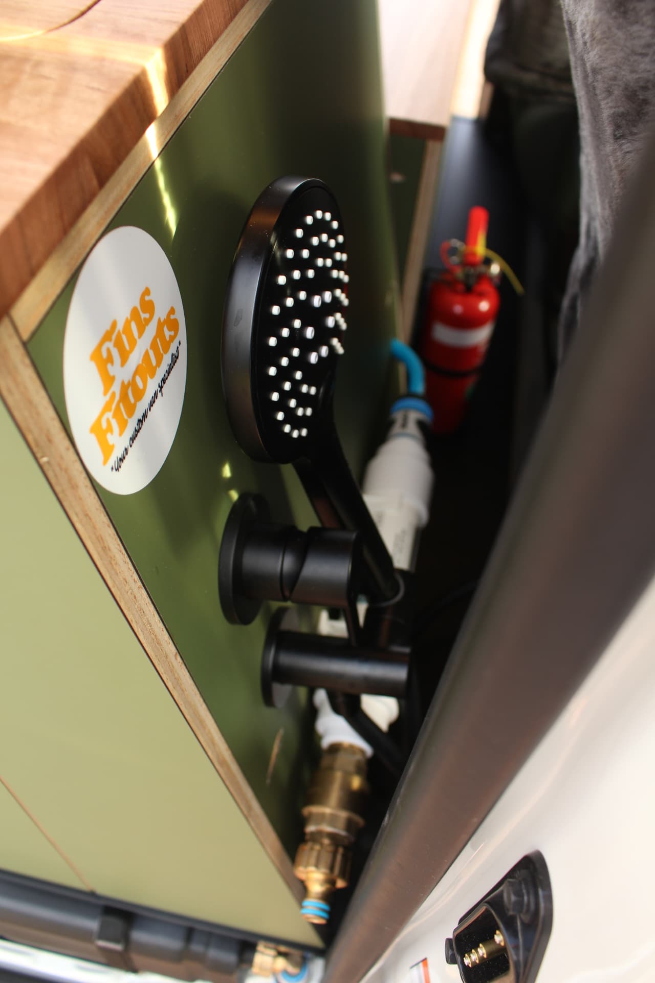 Toyota Hiace 300 Series — Shower head and mixer set into the olive joinery