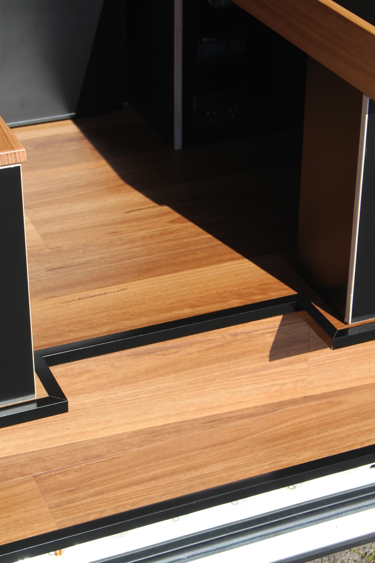 Hiace 200 Series Weekender — Step detail where the joinery meets the floor