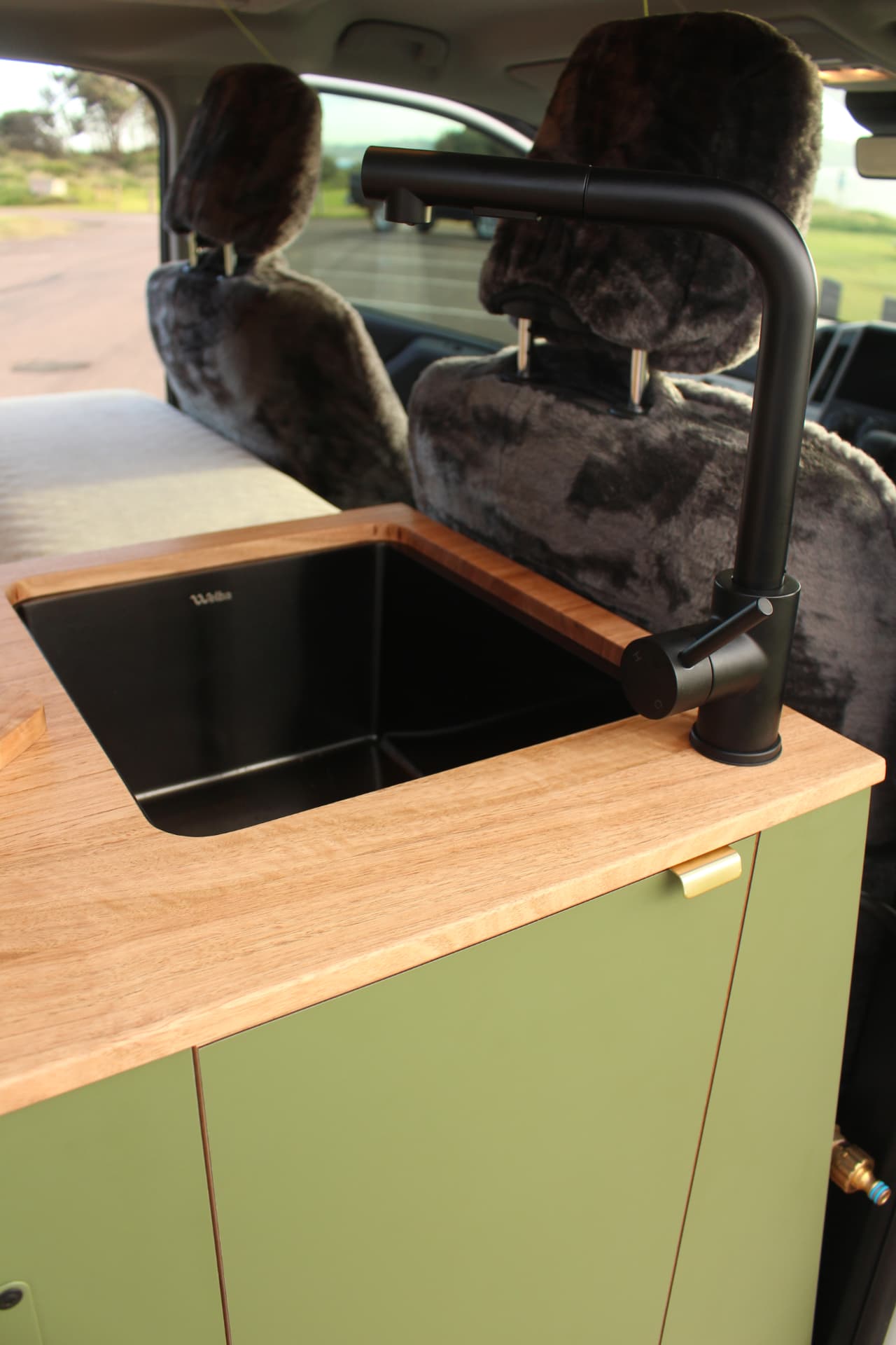Toyota Hiace 300 Series — Undermount sink and black mixer from the side door