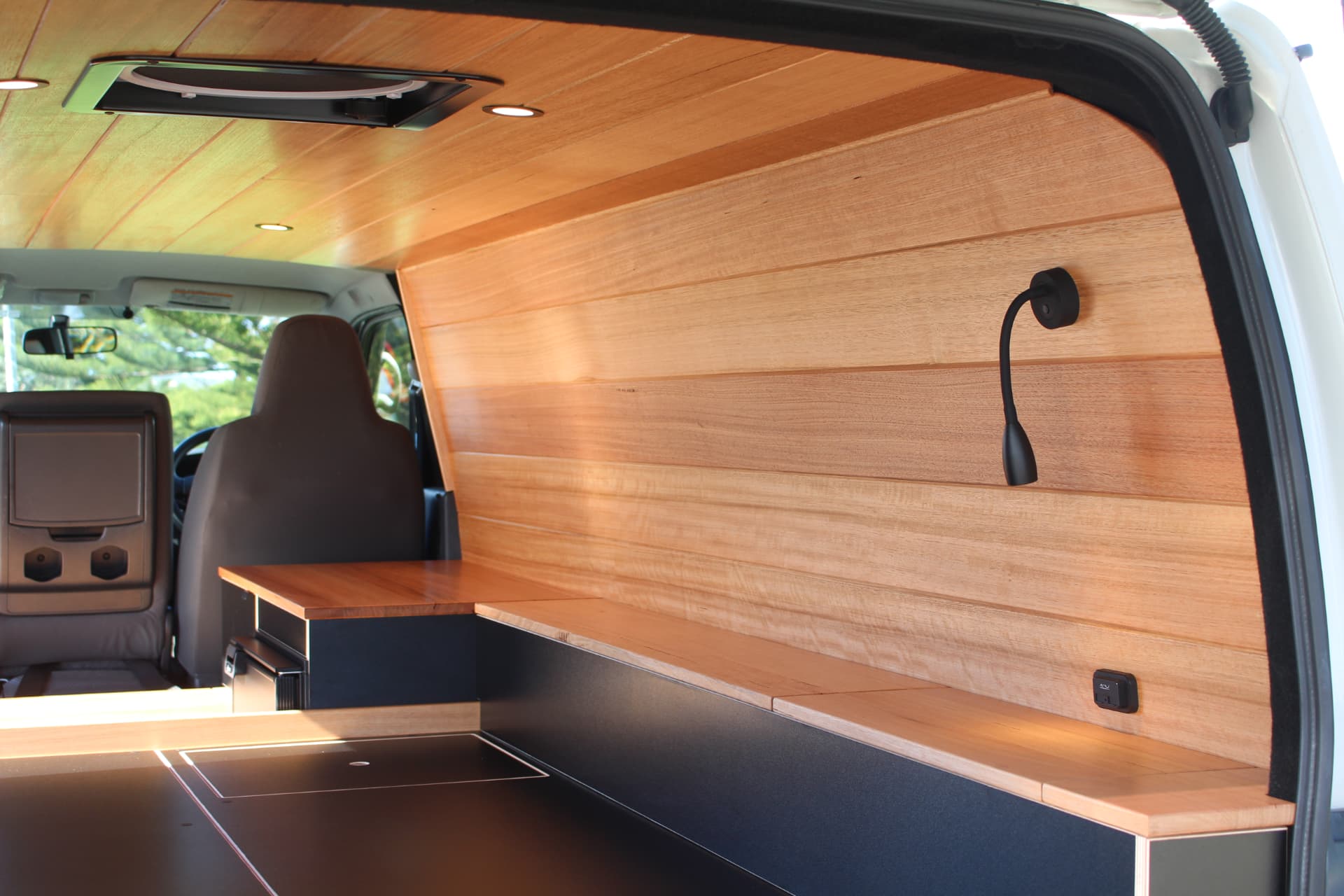 Hiace 200 Series Weekender — Timber-lined side wall and bench
